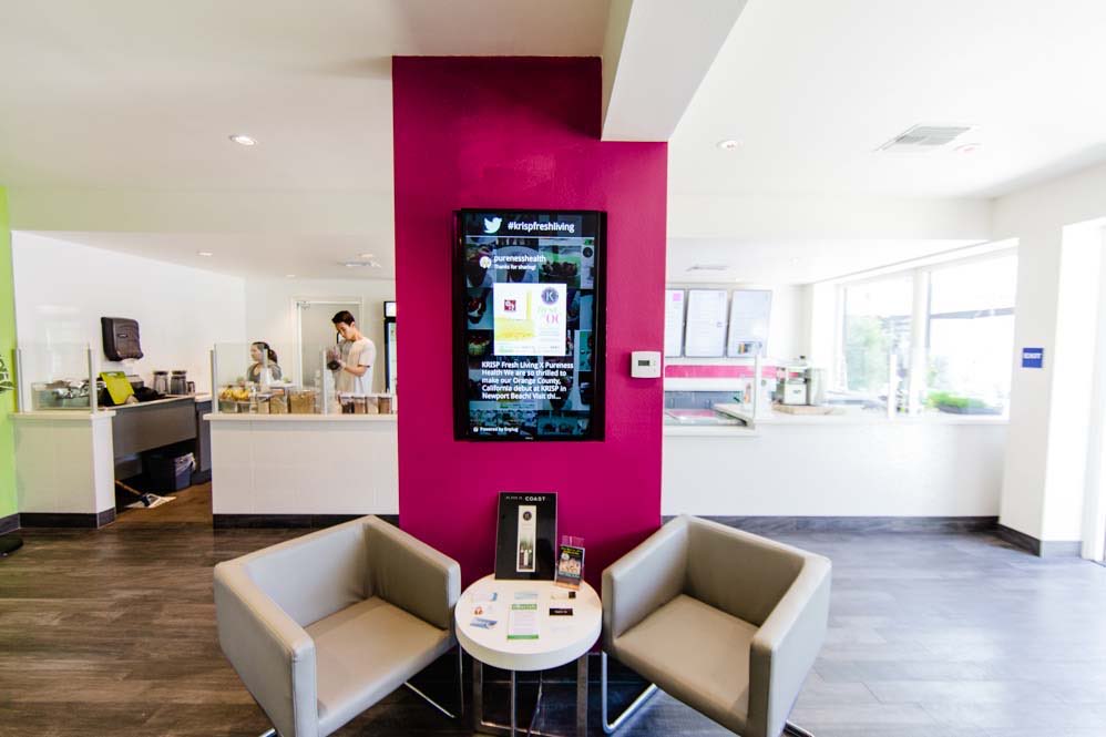 Krisp Juice Bar: Lounge chairs and menu screen